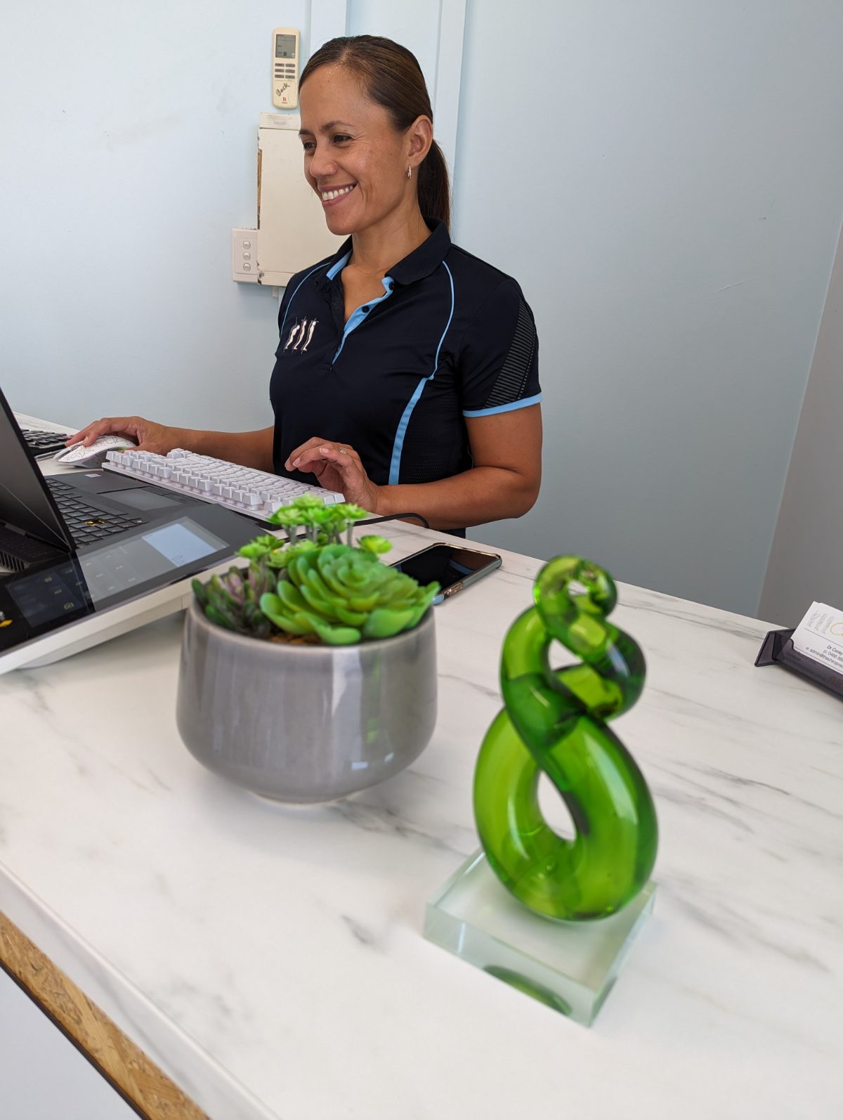 Geraldine at the front desk of The Chiropractice